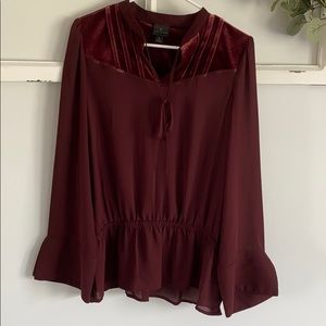 Wine-colored blouse with velvet and tie detail